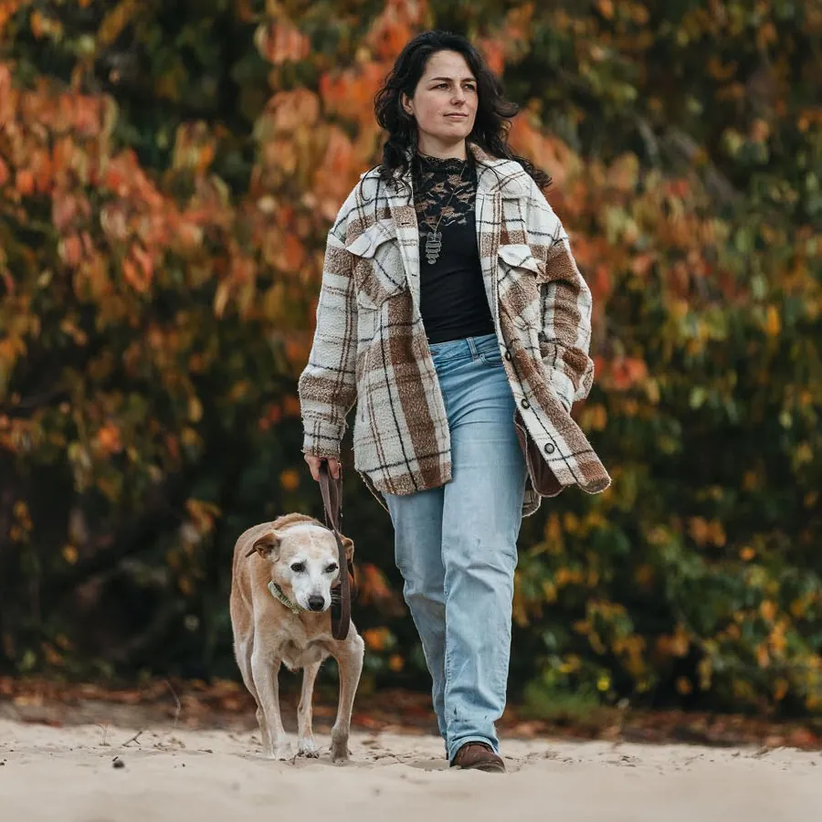 Simone Hervij walking her dog on a sandy path